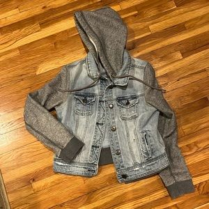 Jean jacket with heather grey hoodie and sleeves.